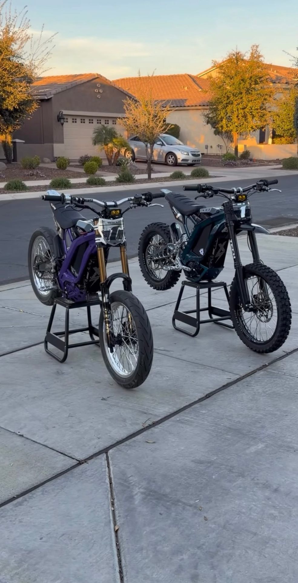 Twin Sur-Ron builds on stands in driveway