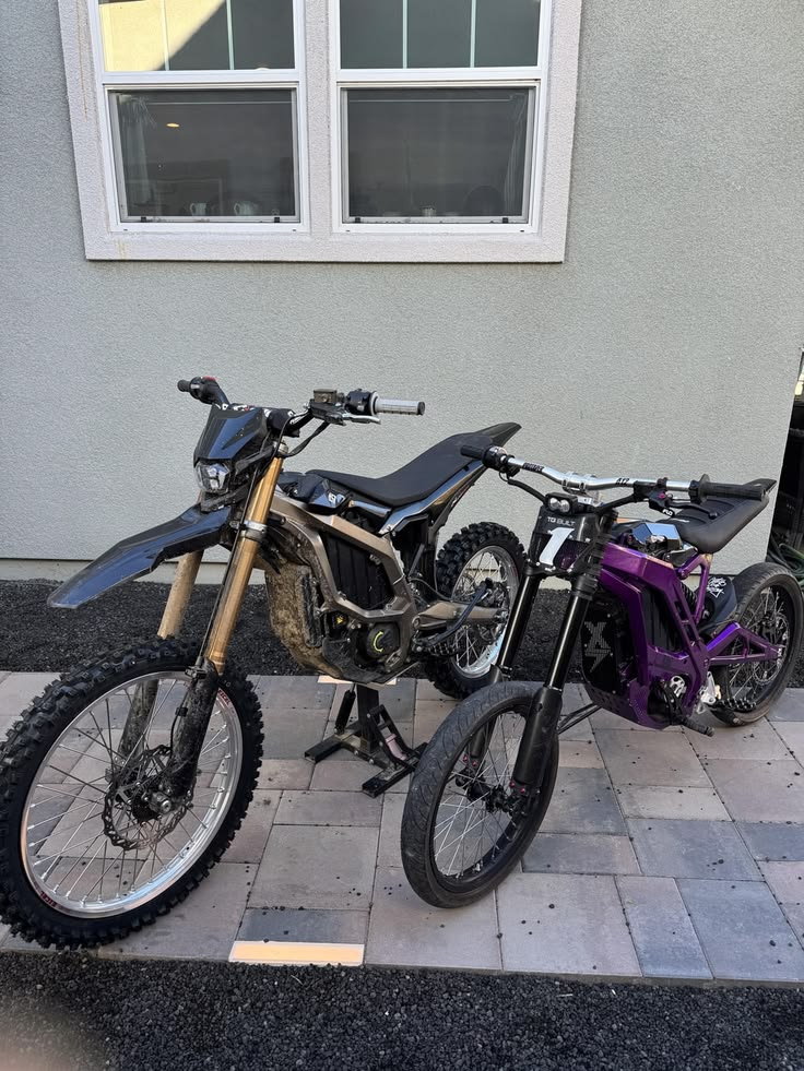Two Sur-Rons parked side by side
